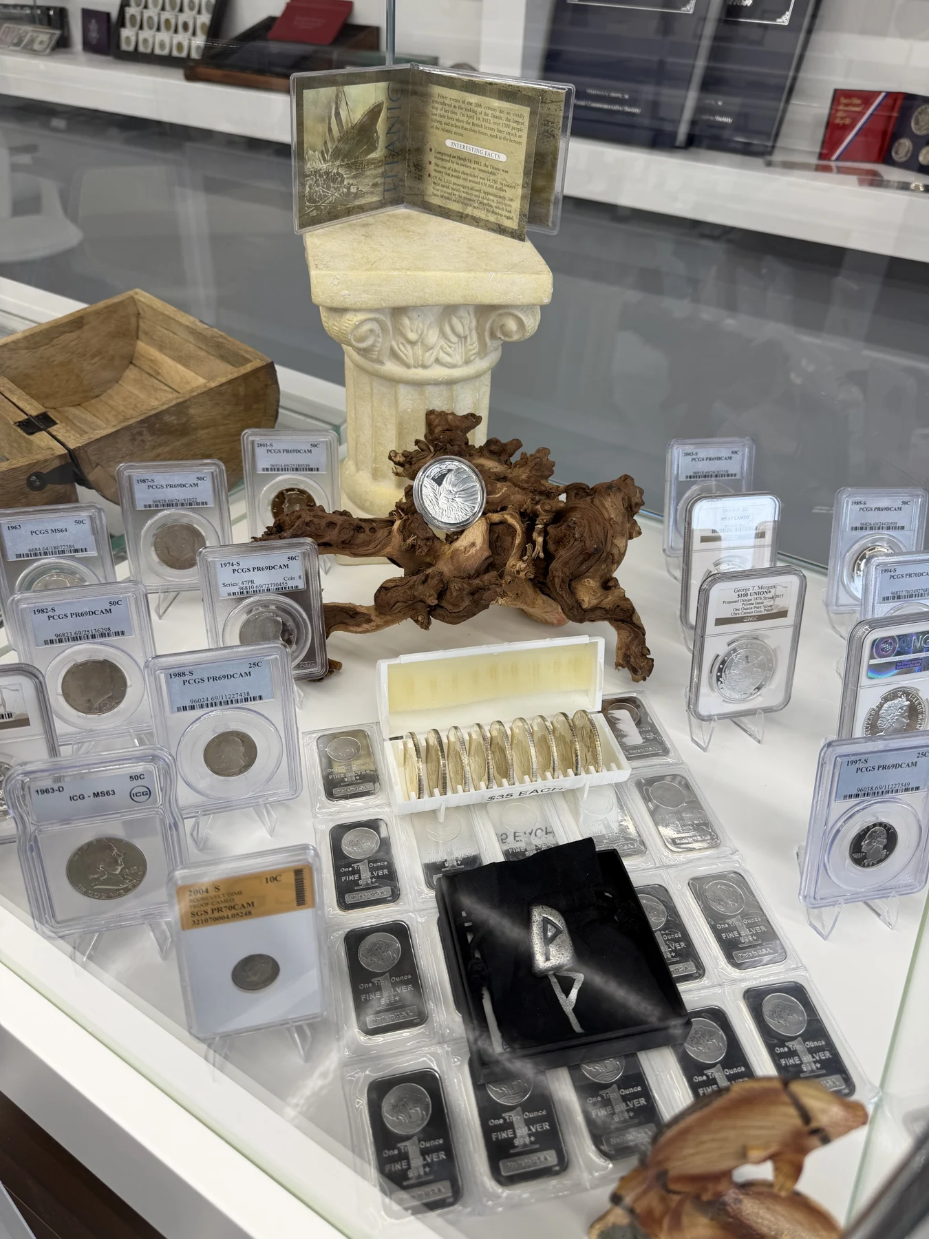 Gold and silver coins and collectible pieces in our store display